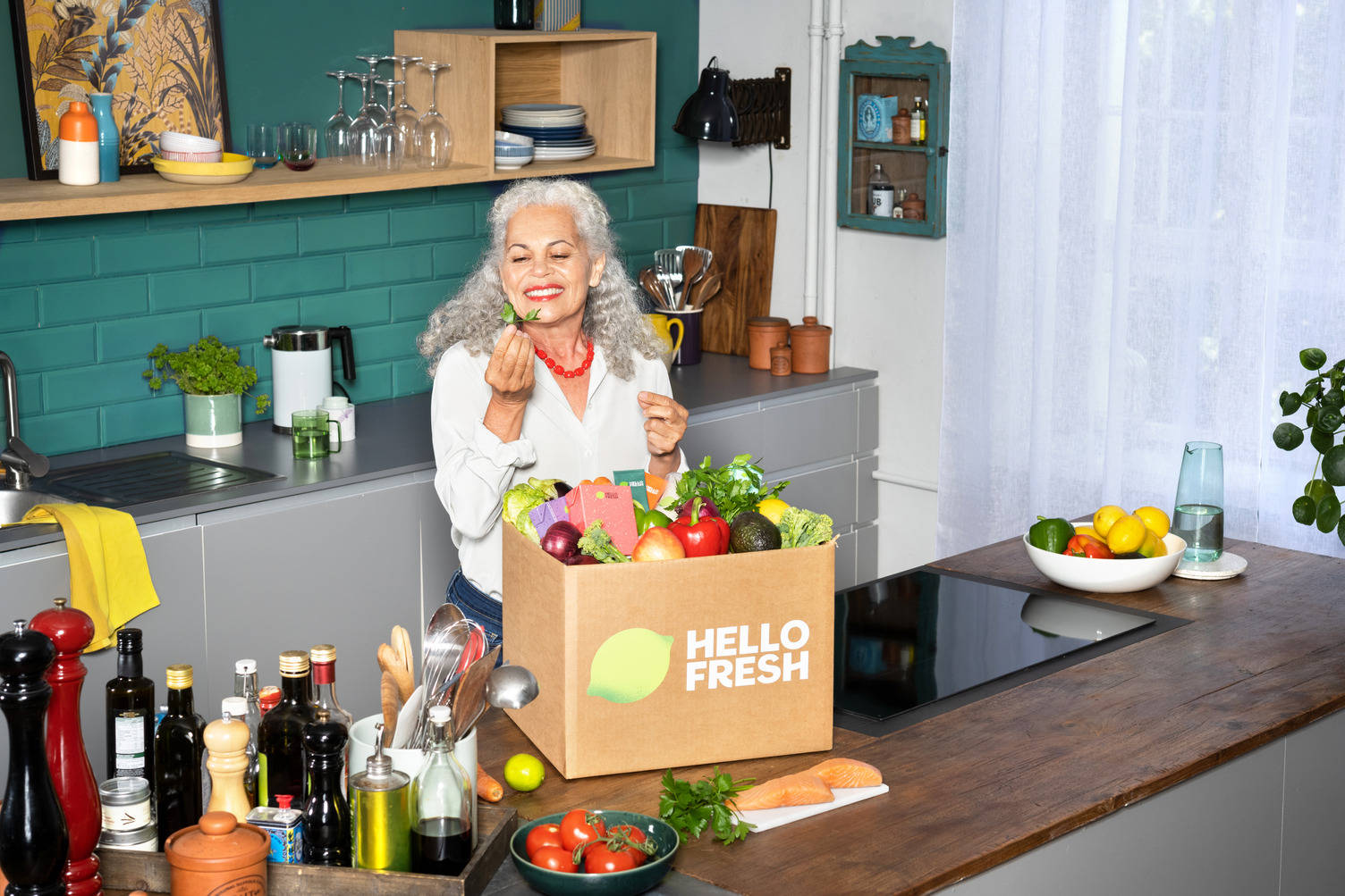 A HelloFresh meal box with fresh ingredients in a kitchen